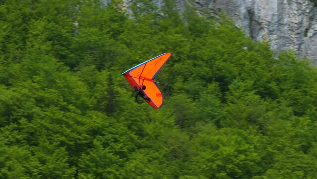 Gliding over a forest in the mountains