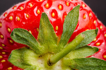 Close-up macro of a fresh strawberry against a dark background