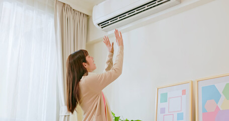 woman use heating at home - obrazy, fototapety, plakaty