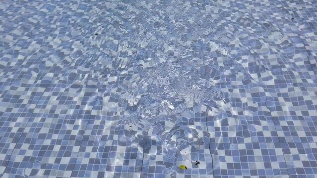 Blue tiles at the bottom of the wavy pool
