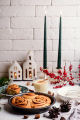 Egg nog cinnamon buns in christmas background