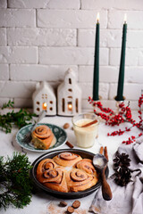 Egg nog cinnamon buns in christmas background