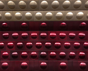 Rows of circles in gold and red metal