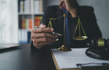 Lawyer businessmฟn working with contract papers and wooden gavel on table in courtroom. Justice and law, attorney, court judge, concept.