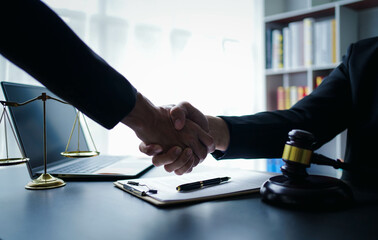 Lawyer businessmฟn working with contract papers and wooden gavel on table in courtroom. Justice and law, attorney, court judge, concept.