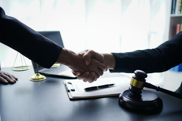 Lawyer businessmฟn working with contract papers and wooden gavel on table in courtroom. Justice and law, attorney, court judge, concept.