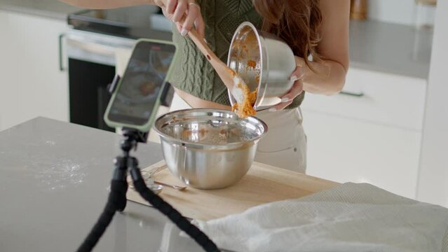 Girl filming fall baking recipe, pumpkin puree