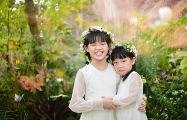 two sisters in different moods, one happy one sad.