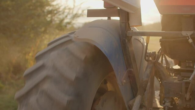 Close up of tractor wheel driving during golden hour