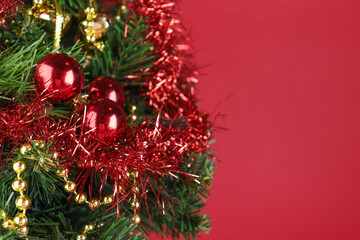 Christmas tree close-up, spruce branches with red balls 