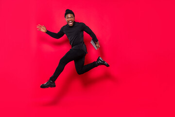 Fototapeta na wymiar Full length body size view of handsome trendy cheery guy jumping running isolated over vivid red color background