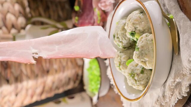 North italian traditional dish. Canederli or Knodel in broth with green onion, typical pasta for Trento, Alps, Alto Adige, Italian, Austrian cuisine. High quality 4k footage. Vertical video