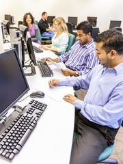 Adult Education: Technology Class. Mature students at work in their college computer suite. From a series of related images on the subject.