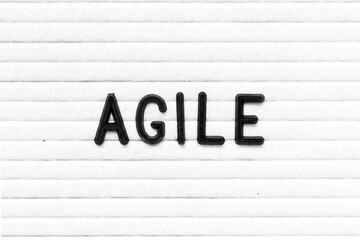Black color letter in word agile on white felt board background