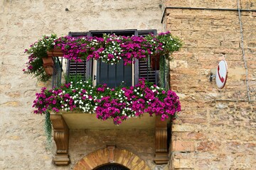 Fototapeta na wymiar flowered balconies in the village of Spello in the city of Perugia, Umbria, Italy