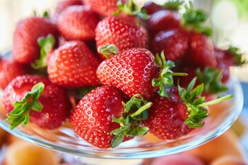 Fruit red ripe strawberries, several berries, close-up. Ecological products grown in the garden, vegetarian diet.