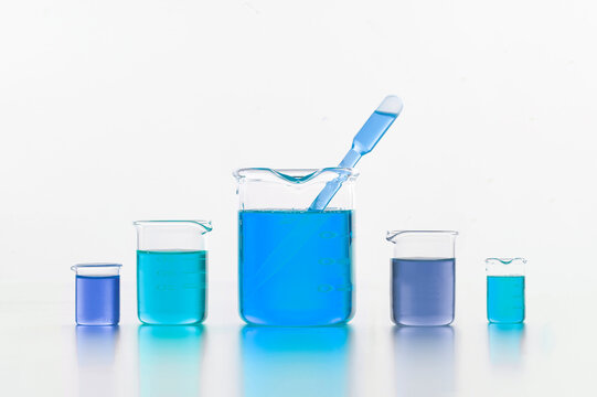 Set of chemical flasks with blue substance in lab