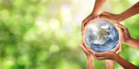 Conceptual symbol of multiracial human hands surrounding the Earth globe. Unity, world peace,...