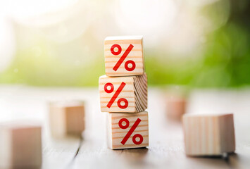 Interest rate financial and mortgage rates concept.Wooden cube block increasing on top with icon...