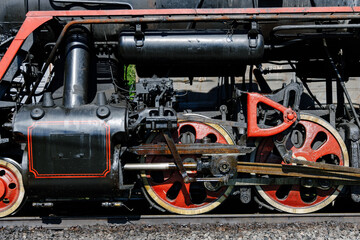 Detail of old red wheels of a retro train
