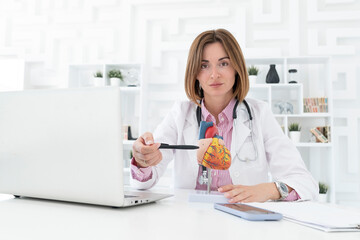 Portrait of young female doctor cardiologist working in office of modern clinic