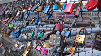 Love Lock Padlocks on Bridge with Lovers and friends initials on it in romantic gesture