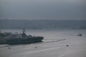 National Geographic cruiseship or cruise ship liner Quest arrival to port of San Diego harbor with sailing boats, yachts and navy vessels