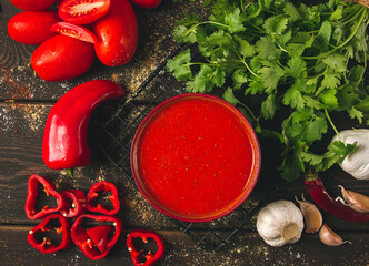 Tomato sauce, tomatoes and sweet pepper, Georgian Satsebeli sauce, with ingredients on a dark...