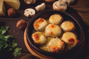 Traditional Georgian dish, appetizer, stuffed mushrooms, Sulguni cheese, baked in a Ketzi clay pan, on a wooden table, close-up, no people,