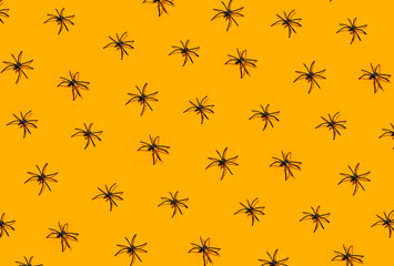 Repeated spiders on orange background. Halloween party
