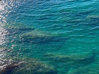 Fototapeta na wymiar Sea turquoise blue water shiny sparkling glittering surface.