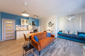 New modern living room with kitchen. New home. Interior photography. Wooden floor.