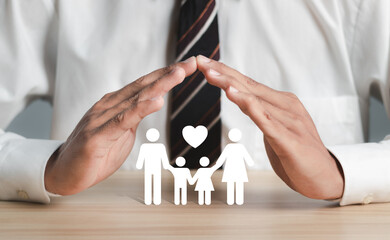Family care concept. Businessman with protective gesture and family, life, health and house...
