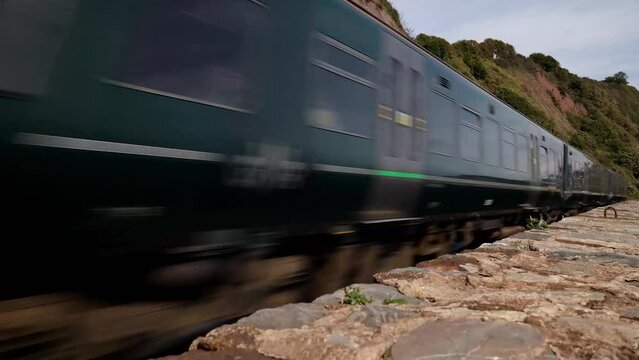 Teignmouth, Dorset UK - September 2022: GWR train travelling towards camera in 4k. Real time motion of train travel