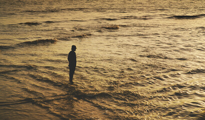Sunrise on the beach with fisherman