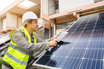 Blue Solar Photo voltaic panels system of apartment building on sunny day. Renewable ecological green energy. maintenance panels collect solar energy. Engineer holding tablet.