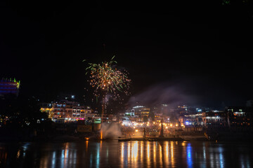 The Ganga River reflecting the festivities in the temples during the night.