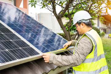 Blue Solar Photo voltaic panels system of apartment building on sunny day. Renewable ecological...
