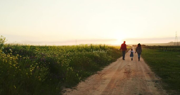 Man, woman or child holding hands on farm and sunset walking on nature environment path, agriculture dirt road or countryside soil. Farming family, girl or parents bonding on sustainability landscape