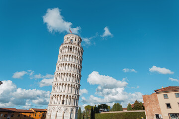 Amazingly beautiful historical building tower with Romanesque architecture and columns on blue sky...