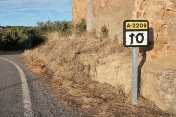 señal de kilometraje y carretera, señal con nombre de carretera y km 10, señal con agujeros de...