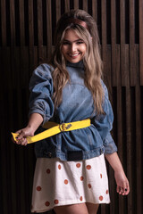 Smiling girl posing and tightening her belt