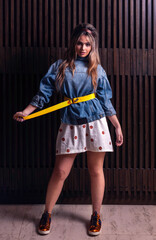 Young woman posing and tightens her belt