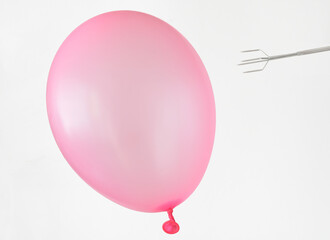 A ballon and a fork, risk management, courage,problem solving and troubleshooting business metaphor or concept.White background, good copy space.