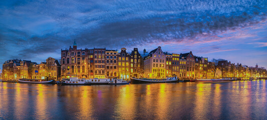 Amsterdam Netherlands, night panorama city skyline of Dutch house at canal waterfront