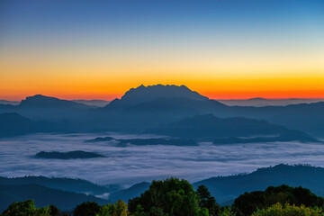 Tropical forest nature landscape view with mountain range sunrise with moving cloud mist at Huai Nam Dang National Park, Chiang Mai Thailand