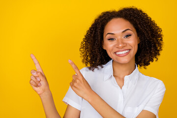 Photo of gorgeous adorable lovely girl with wavy hairdo dressed white blouse directing empty space...