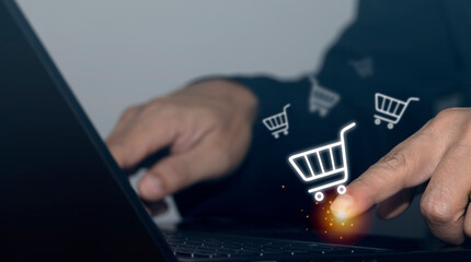 Businessman using laptop and online shopping site with online shopping icon.