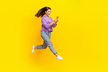 Fototapeta na wymiar Full length photo of positive blogger runner user fly air hurry shopping sale discount go empty space isolated on yellow color background