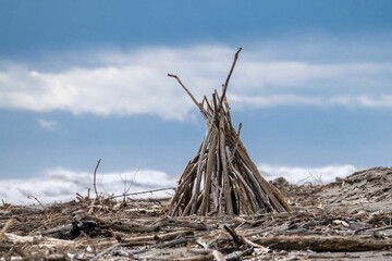 Closeup of a small wooden tipi against the background of blue sky. Kapiti Coast, New Zealand. © Philip Armitage/Wirestock Creators